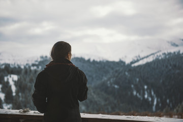 Girl with a cup of hot drink with a mountain background