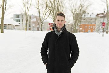 Beautiful winter portrait of a handsome man in a knitted hat © Louis-Paul Photo