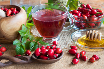 Rose hips and rose hip tea on a wooden table
