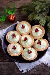 Tartlets with avocado pasta, cottage cheese, fish caviar and pomegranate.