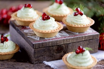 Tartlets with avocado pasta, cottage cheese, fish caviar and pomegranate.