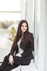 portrait of a young prospective female employee on the background of a large window