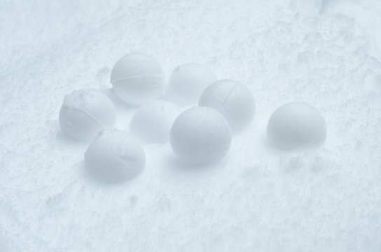 Group of snowballs on a textured snow background. Close up photo.