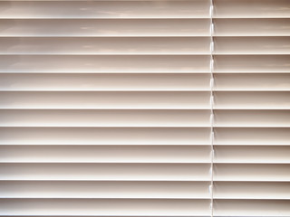 Closed window blinds background in sunny day