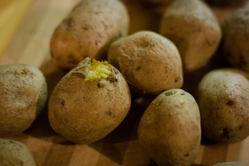 hot boiled potatoes on a wooden board.