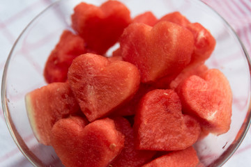 Watermelon heart shaped peaces served with ice, refreshing fruit salad 