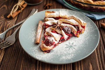 Delicious homemade pie with berries on a wooden background