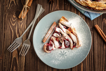 Delicious homemade pie with berries on a wooden background