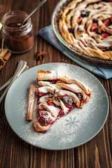 Delicious homemade pie with berries on a wooden background
