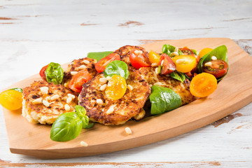 Ricotta pancakes with spinach, tomatoes, basil and pine nuts sal
