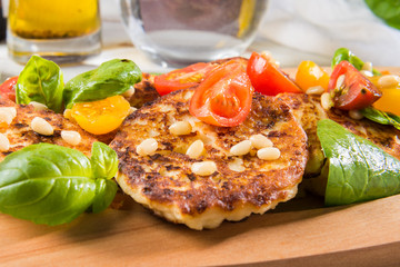 Ricotta pancakes with spinach, tomatoes, basil and pine nuts sal