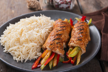 Grilled chicken rolls from chicken fillet stuffed sweet peppers