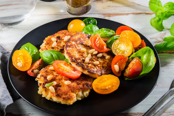 Ricotta pancakes with spinach, tomatoes, basil and pine nuts sal