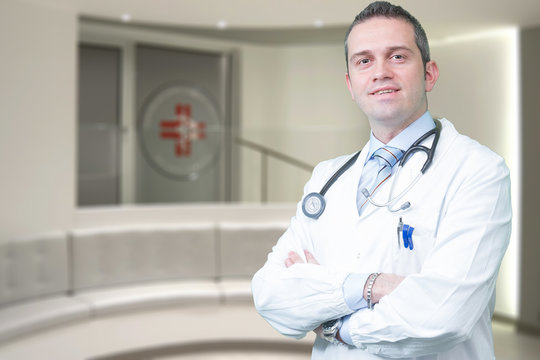 stock photo smart doctor with a stethoscope around his neck on the hospital blurred background health care