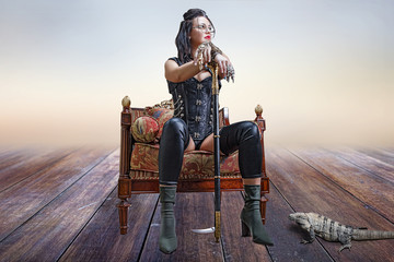 Portrait of a beautiful girl in a steampunk clothes, in a chair with an iguana