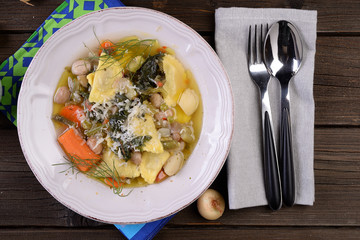 Plate of vegetarian soup with stuffed agnolotti 