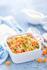 Green peas stewed with carrots in creamy milk white sauce, vegetable stew