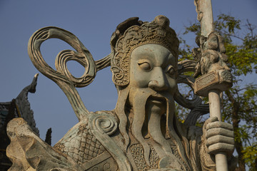 Fototapeta na wymiar Demon Figures guarding the entrance to Wat Pho, a historic temple in Bangkok, Thailand