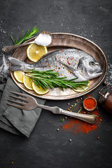 Fresh raw dorado fish with ingredients for cooking. Top view
