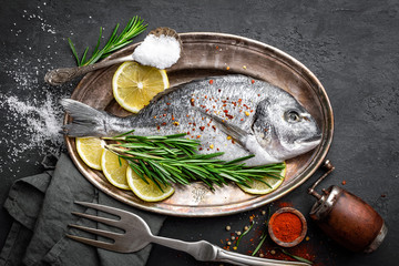 Fresh raw dorado fish with ingredients for cooking. Top view