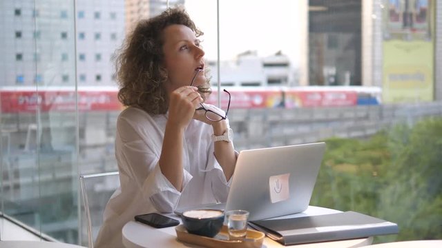 Young Business Woman Using Laptop At Coworking Cafe. 4K.