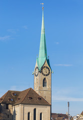 Fototapeta na wymiar Clock tower of the Fraumunster cathedral in Zurich, Switzerland - a well-known architectural landmark of the city