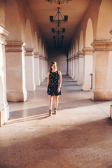 Woman in Dress in Arched Walkway