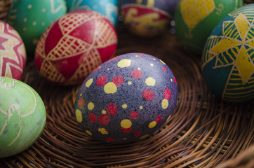 colorful painted Easter eggs in a woven straw basket
