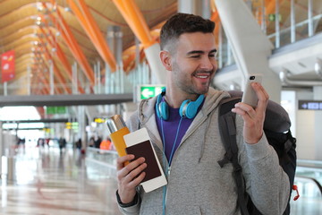 Joyful traveler using smartphone in the airport © ajr_images