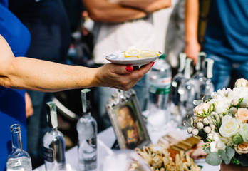 a woman holds a plate of lemon