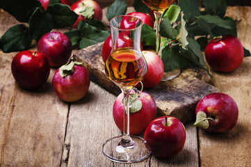 French apple strong alcoholic drink, still life in rustic style, vintage wooden background,...