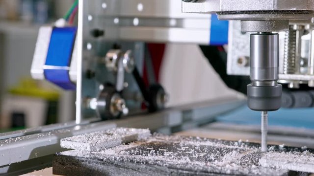 CNC milling machine proceccing plastic detail.