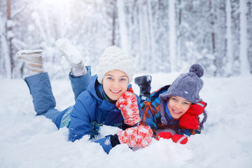 Happy children playing on snowy winter day.