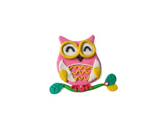 The cute owl is on a branch made from plasticine clay on white background, lovely animal dough