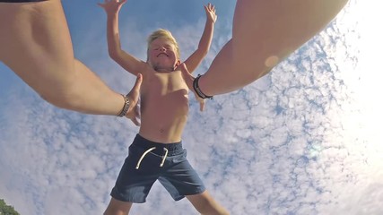 POV view. Happy father and son playing on tropical beach, carefree happy fun smiling lifestyle
