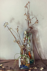 Still life with dry flowers in a glass vase