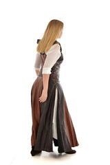 Fototapeta premium full length portrait of girl wearing brown fantasy costume, standing pose with back to the camera on white studio background. 