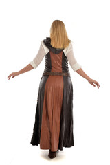 Fototapeta premium full length portrait of girl wearing brown fantasy costume, standing pose with back to the camera on white studio background. 