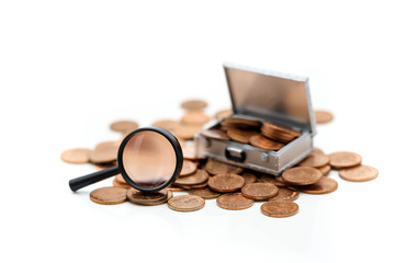 Money or coins in Chest box with Magnifying glass  on white background,business concept.