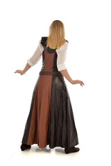 Fototapeta premium full length portrait of girl wearing brown fantasy costume, standing pose with back to the camera on white studio background. 
