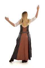 full length portrait of girl wearing brown  fantasy costume, standing pose with back to the camera on white studio background. 