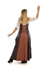 full length portrait of girl wearing brown  fantasy costume, standing pose with back to the camera on white studio background. 