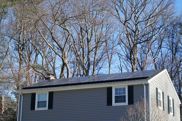 solar panel installed on the house roof in front of winter tree