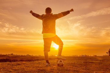 silhouette football player at sunset or sunrise background