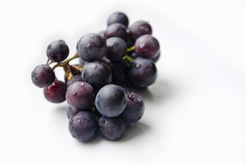 Bunch of blue grapes isolated on white background