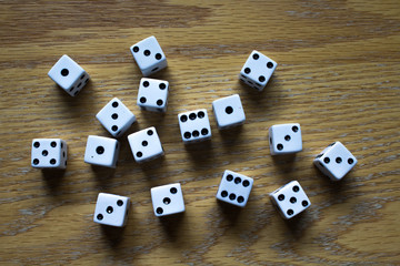 Random White Dice Cubes on an oak table