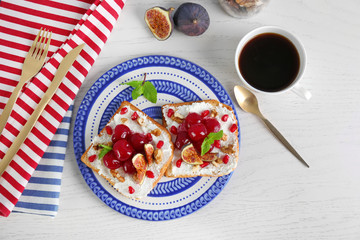 Delicious toasts with fruits on plate