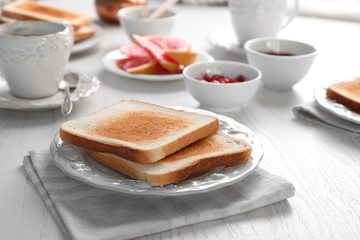 Plate with yummy fresh toasts on table