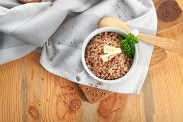 Dish of tasty buckwheat porridge on table, top view