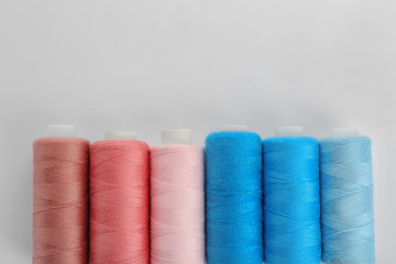 Set of colorful sewing threads on white background